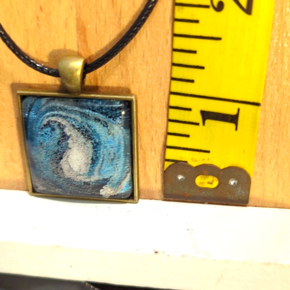 Handmade by me. Resin necklace white,blue,with little silver.leather 18 in cord.